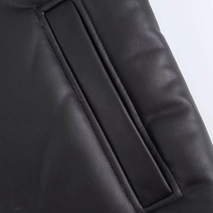 Close-up of black faux leather jacket showing pocket detail and high-quality stitching