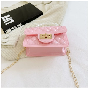 Detail of pink jelly handbag with pearl handle, diamond quilted pattern and gold chain