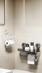 Detail of wall-mounted vacuum suction toilet paper holder with top shelf storage