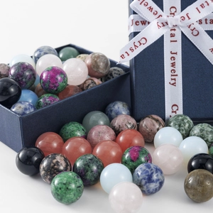Close-up of polished 16mm natural crystal balls and decorative blue jewelry gift box