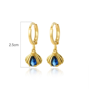 Detail of 2.5cm gold shell earrings featuring sparkling blue teardrop-shaped gemstones