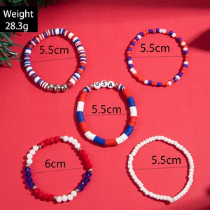 Detail of five-piece red white and blue beaded bracelets featuring USA charms and beads