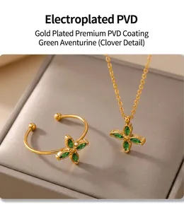Detail of PVD plated gold clover jewelry set with green zircon necklace and open ring