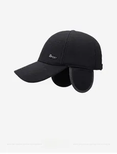 Detail of winter baseball cap featuring foldable ear flaps and metal sport emblem