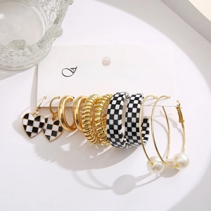 Detail view of 6-pair gold earring set featuring faux pearls and leopard patterns
