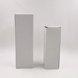 Macro view of two minimalist white square milk carton style gift boxes on white background