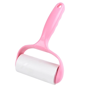 Pink lint roller with white sticky paper roll for clothing cleaning and hair removal