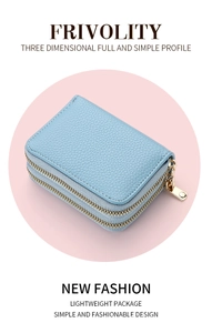 Detail of light blue pebble grain leather card holder with dual gold zippers and sleek design