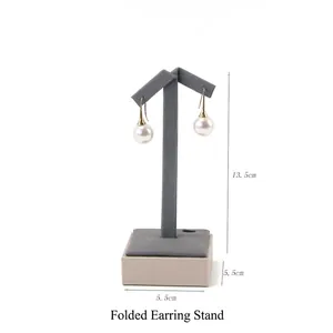 Detail of grey velvet T-bar earring display stand with square base for jewelry display