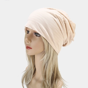 Minimalist light beige knitted slouchy beanie with thin ribbed texture for men and women