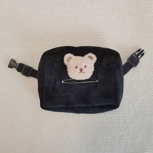 Detailed view of black plush car tissue bag with cute teddy bear embroidery and nylon buckle