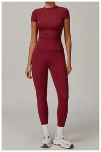 Detail of dark red brushed yoga set featuring slim fit short sleeve top and high waist leggings