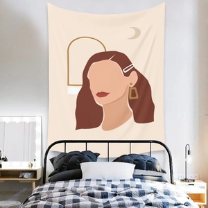 Detailed shot of Bohemian tapestry with abstract female portrait on a cozy bedroom wall
