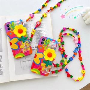 Detailed view of floral phone cases with retro flower charms and colorful beaded lanyards