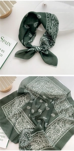 Close-up of dark green paisley square scarf with delicate overlocked edges and soft texture
