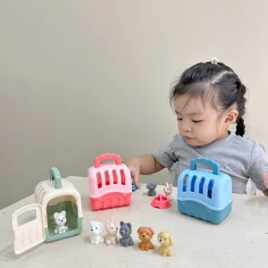 Toddler girl playing with colorful plastic pet cages and small puppy figurines