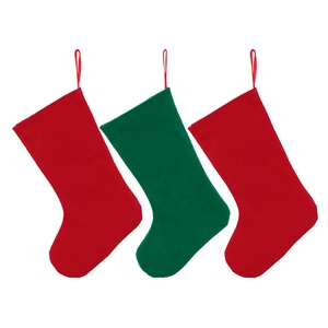 Close-up of red and green felt Christmas stockings hanging with loops on white background