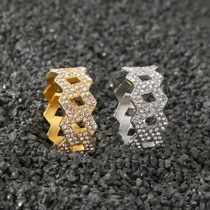 Detail of hip hop rhinestone rings in gold and silver with hexagonal honeycomb links