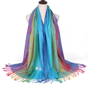 Detail of bohemian pashmina scarf with leaf jacquard pattern and fringe tassels on model