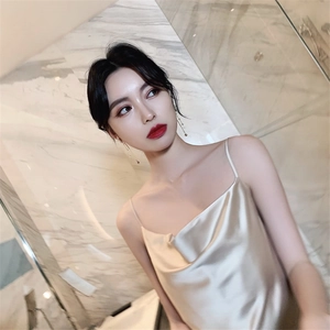 Elegant champagne gold satin slip dress with draped cowl neck shown in bathroom setting