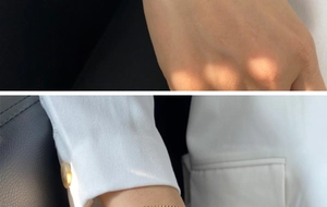 Detailed view of layered gold snake chain bracelet worn on wrist for fashion styling