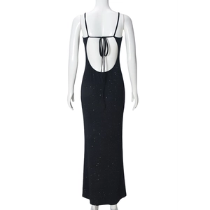 Detail of black backless evening dress with sparkling fabric and bow tie design