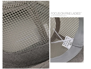 Detail of grey mesh straw hat showing breathable weave texture and 100% paper material label