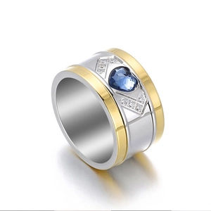Two-tone wide band ring featuring blue heart-shaped crystal and small side diamonds