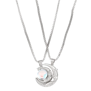 Detail of silver magnetic sun and moon couple necklaces with shimmering rainbow bead