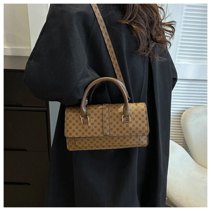 Classic brown logo patterned crossbody bag featuring a leather top handle and shoulder strap