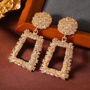 Textured gold geometric earrings featuring circular studs and rectangular hammered pendants