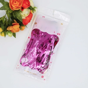 Rose pink foil fringe curtain in packaging for party backdrop decoration with orange flowers