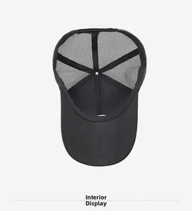 Detailed inner view of black trucker hat showing mesh panels and stitching quality