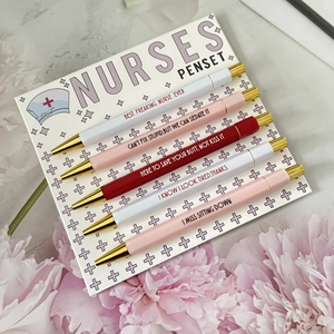Detailed close-up of nurse theme penset with funny quotes on pink marble desk