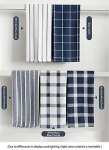 Detail view of five assorted navy blue and white waffle weave kitchen towels on a rack