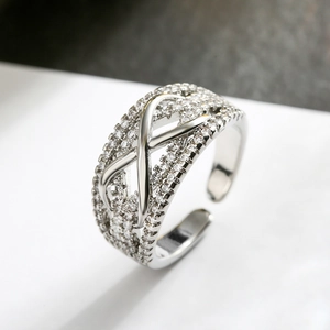 Close-up of silver-plated geometric ring with micro-paved zircons and adjustable band