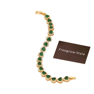 Luxurious 18K gold plated heart bracelet featuring green emerald-cut stones and cubic zirconia