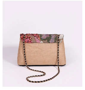 Detail of khaki woven jute bag featuring floral embroidery, sequins, and chain strap