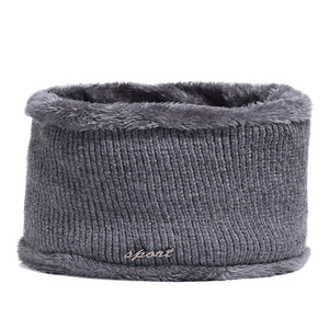 Detail of gray knitted neck warmer with thick faux fur lining and sport metal tag
