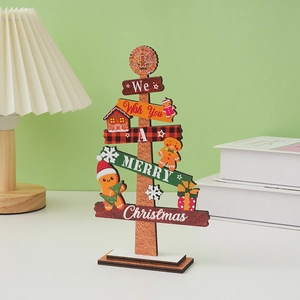 Close-up of wooden Christmas tree tabletop decor with gingerbread man and festive patterns