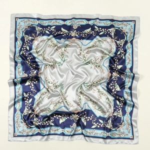 Detailed view of square satin scarf showing elegant lily of the valley floral patterns