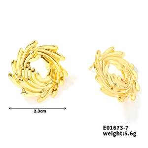 Detailed view of 2.3cm golden spiral stud earrings with textured scroll design and weight