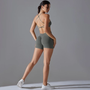 Detail of cross back sports bra and high waist scrunch leggings in dark green