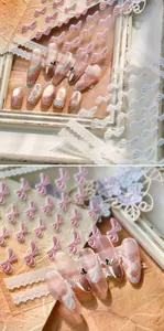 Macro view of 3D embossed pink and white bow nail stickers with pearl luster finish