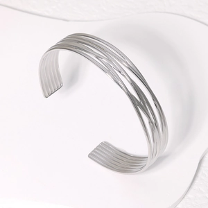Minimalist silver multi-layer open cuff bracelet with geometric lines on white stone