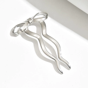 Silver bow hair pin with minimalist wavy U-shape metal design for women's hairstyles