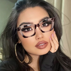 Close-up of tortoise shell square glasses frame on model showing vintage pattern