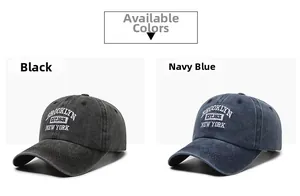 Detail view of cotton baseball caps in washed black and navy blue with Brooklyn embroidery