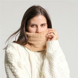 Close-up of soft brown plush neck warmer scarf on model wearing white knit sweater