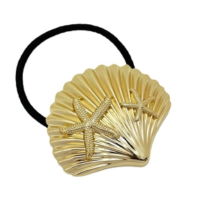 Metallic gold starfish and shell hair tie with black elastic band on white background